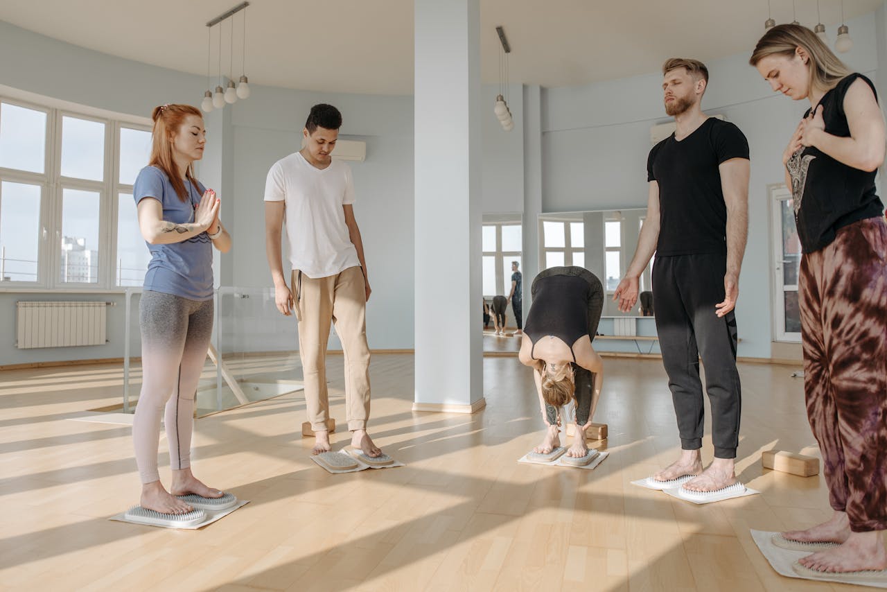 gallery-03 Participants in a yoga class practice meditation and relaxation on sadhu boards.